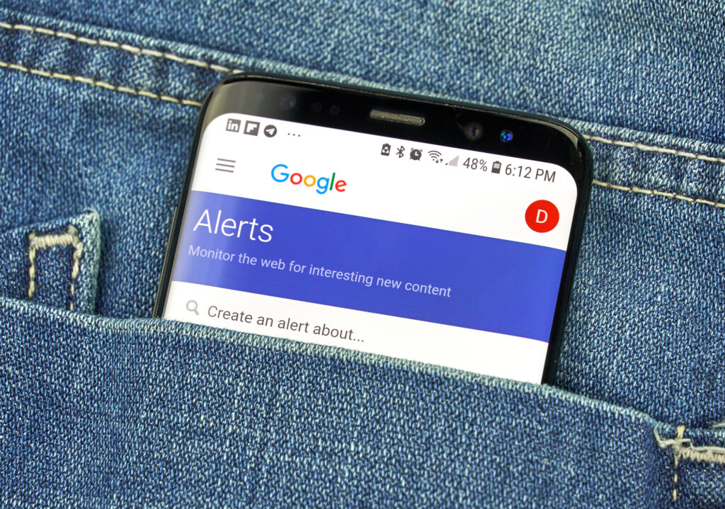 Google Alerts on a phone screen in a pocket