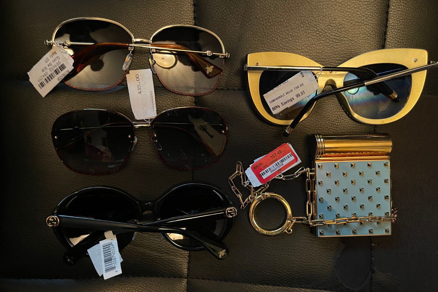 Various luxury designer sunglasses and accessories with Nordstrom Rank liquidation salvage price tags