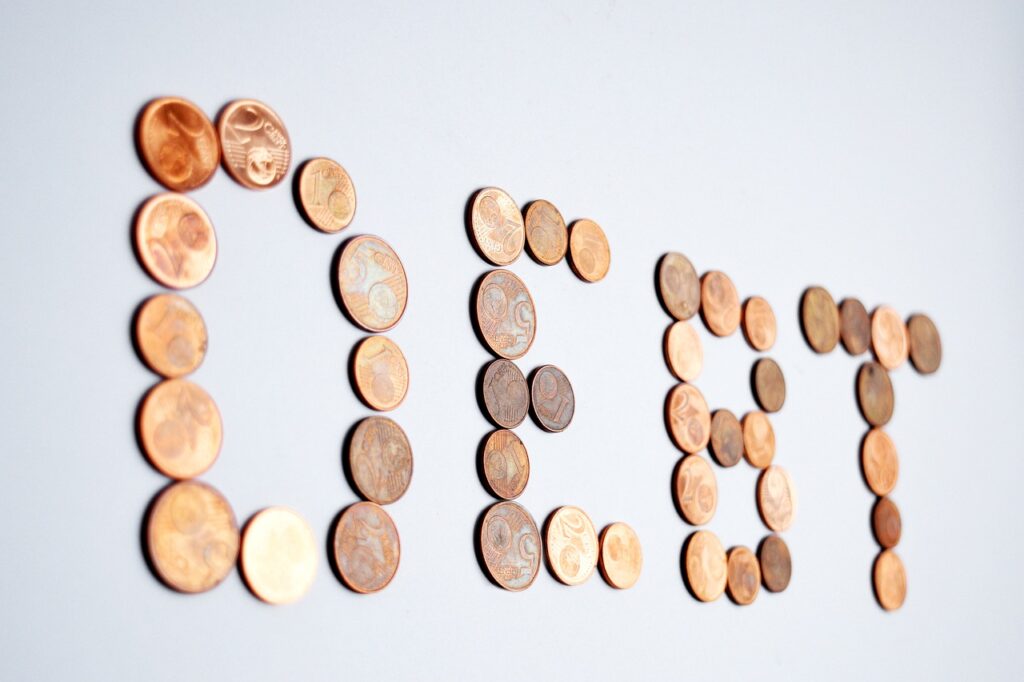 debt spelled out with pennies