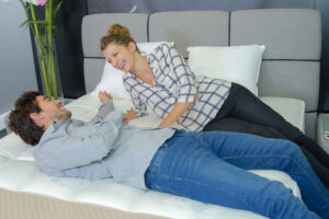 Couple layed on bed in showroom