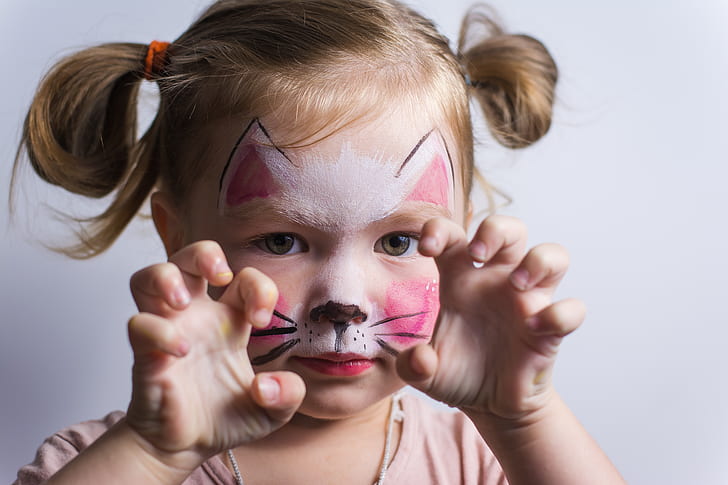 face painting - girl with face paint showing cat claws