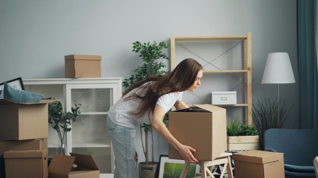 A woman packing her stuff for relocation.