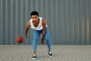 a man dribbling a basketball representing 50 Inspiring Hustle Quotes