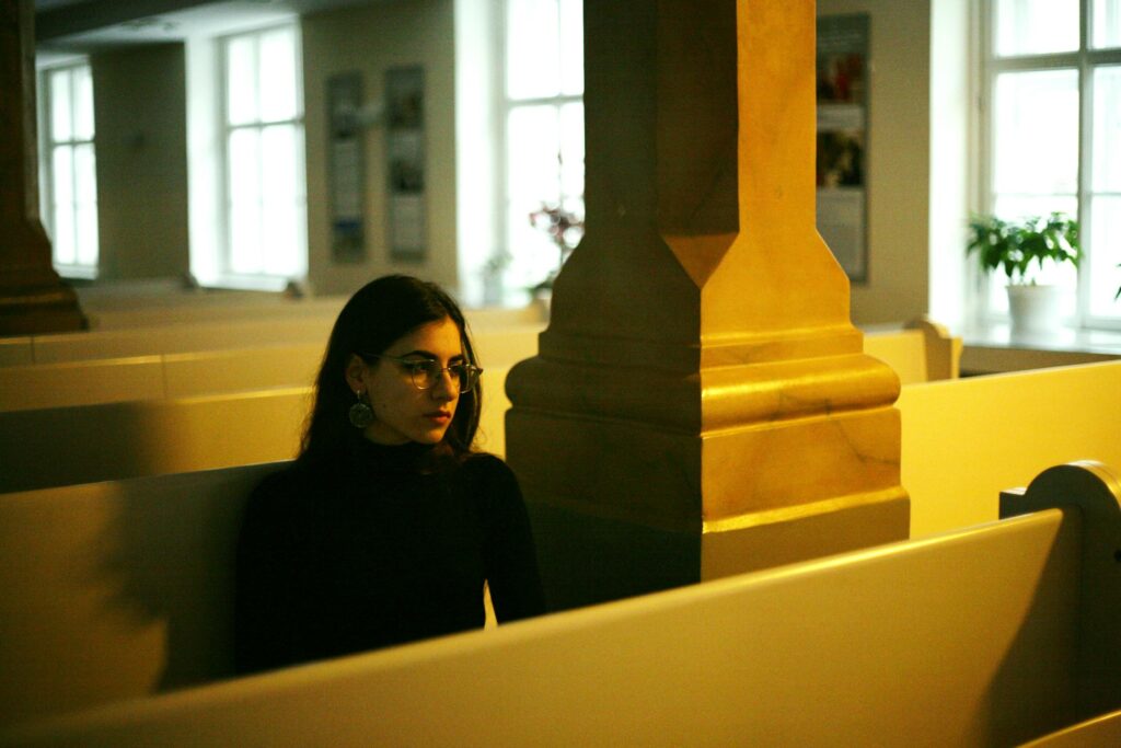 woman sitting in religious place of worship