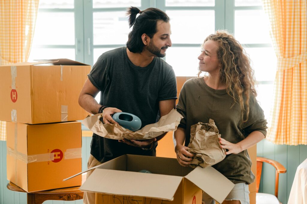 Two people packing moving boxes.