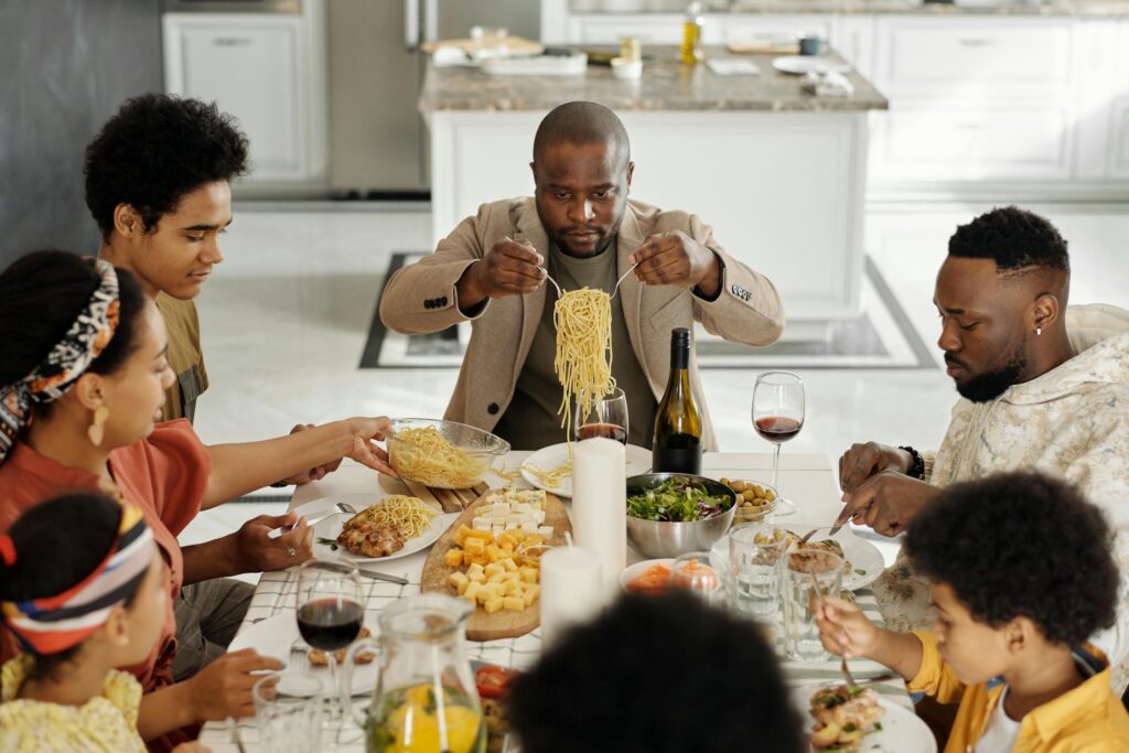 family eating spaghetti and cheese