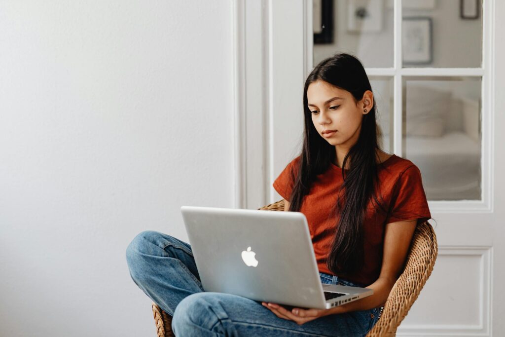 13-year-old girl working on laptop