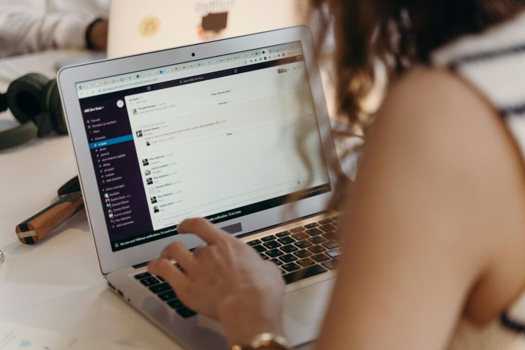 Person browsing the internet on a laptop with multiple browser tabs open, highlighting the use of web tools for online shopping and saving money.