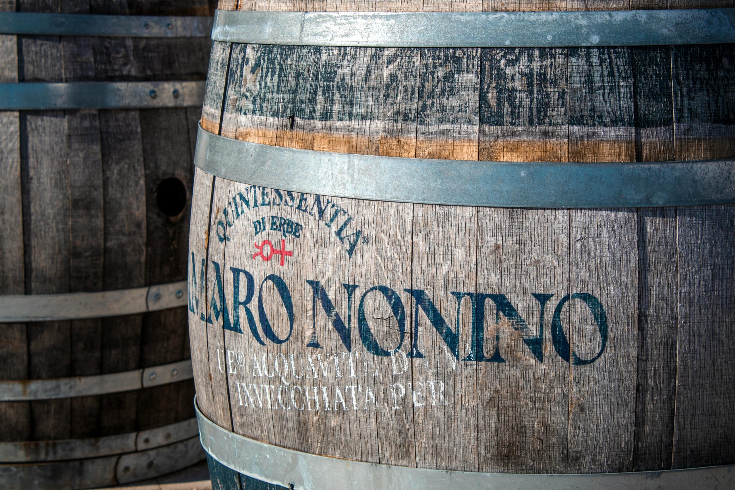Close-up of aged wooden whiskey barrels, symbolizing investment opportunities in casks and spirits.