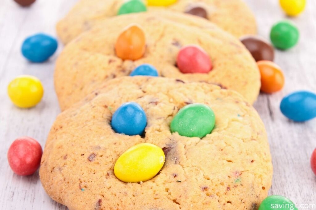 Close-up of homemade cookies topped with colorful chocolate candies, made using leftover Halloween candy.