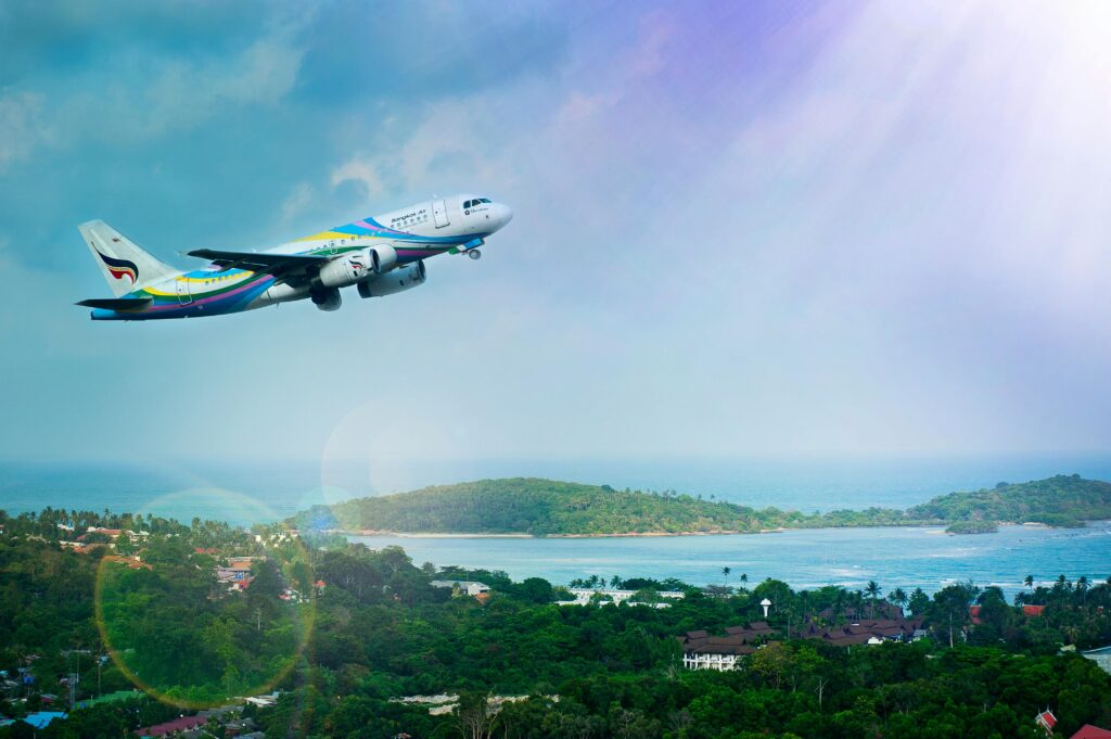 Airplane taking off over a tropical island, symbolizing affordable travel and adventure.
