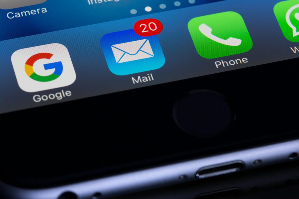 Close-up of a smartphone screen showing a mail app with new message notifications.