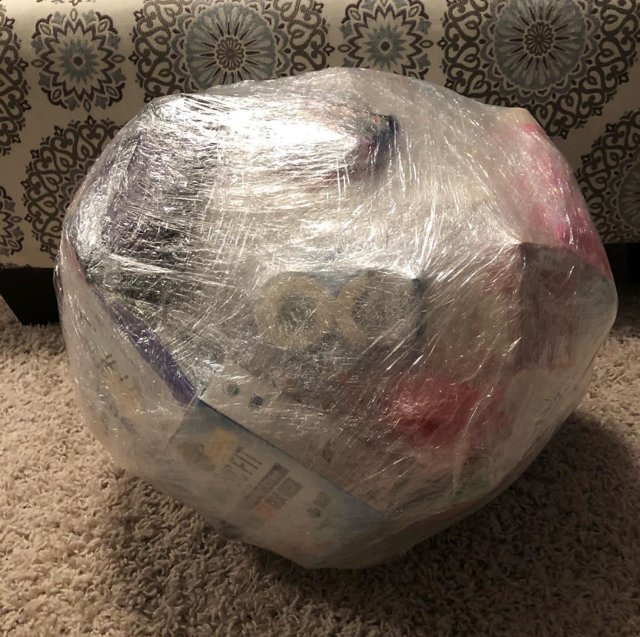 Saran wrap ball game filled with small gifts and prizes for a cheap and fun Christmas party game