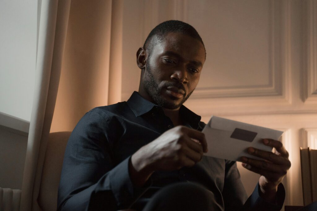 Man reading a Social Security overpayment notice or financial letter at home
