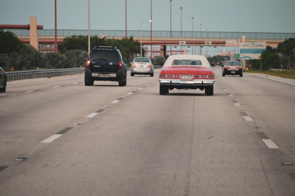 Cars driving on a highway during a used car buying and VIN check concept