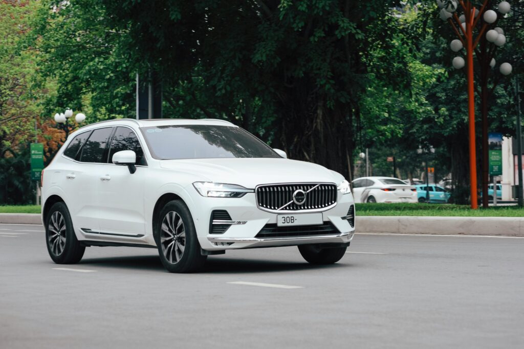 White SUV driving on city street representing one of the best car colors for resale value