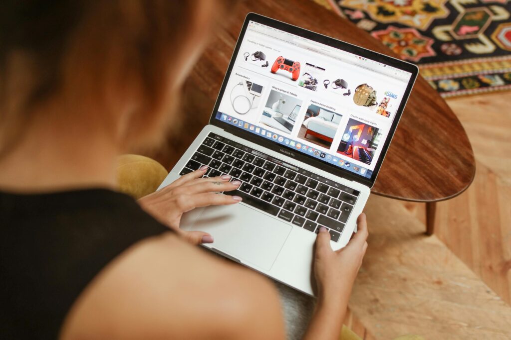 Person shopping online on a laptop while browsing products, representing online penny auctions and digital bidding websites.