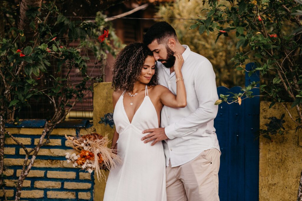 Couple embracing outdoors during a small, intimate wedding celebration, highlighting the trend toward simpler and more affordable weddings.