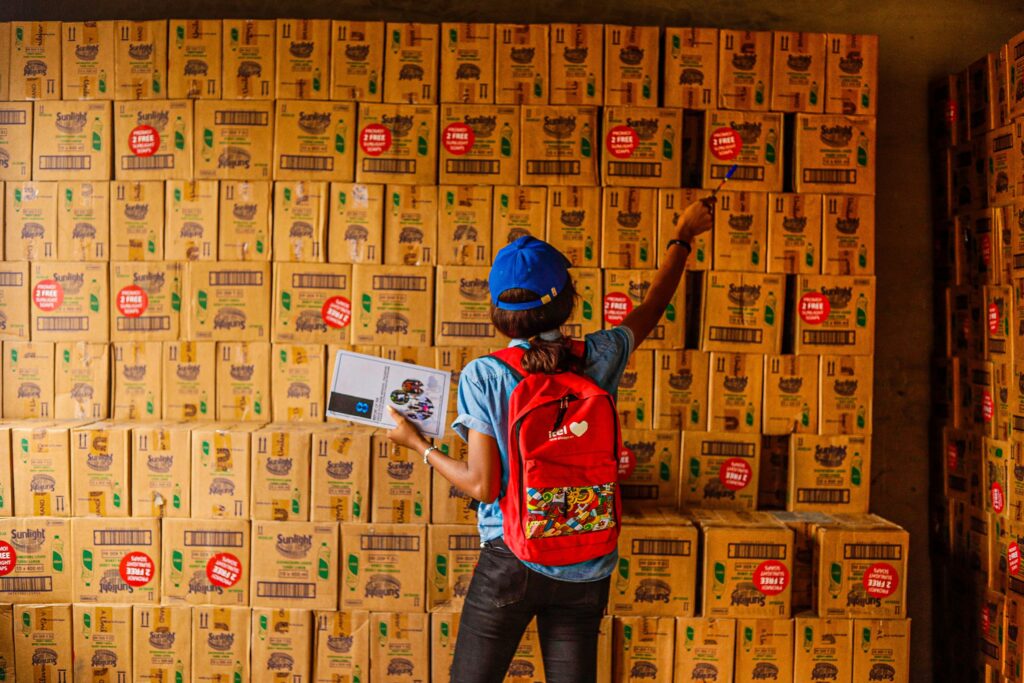 Warehouse filled with stacked casepack boxes representing liquidation inventory and wholesale merchandise for resale on Whatnot and other online marketplaces.