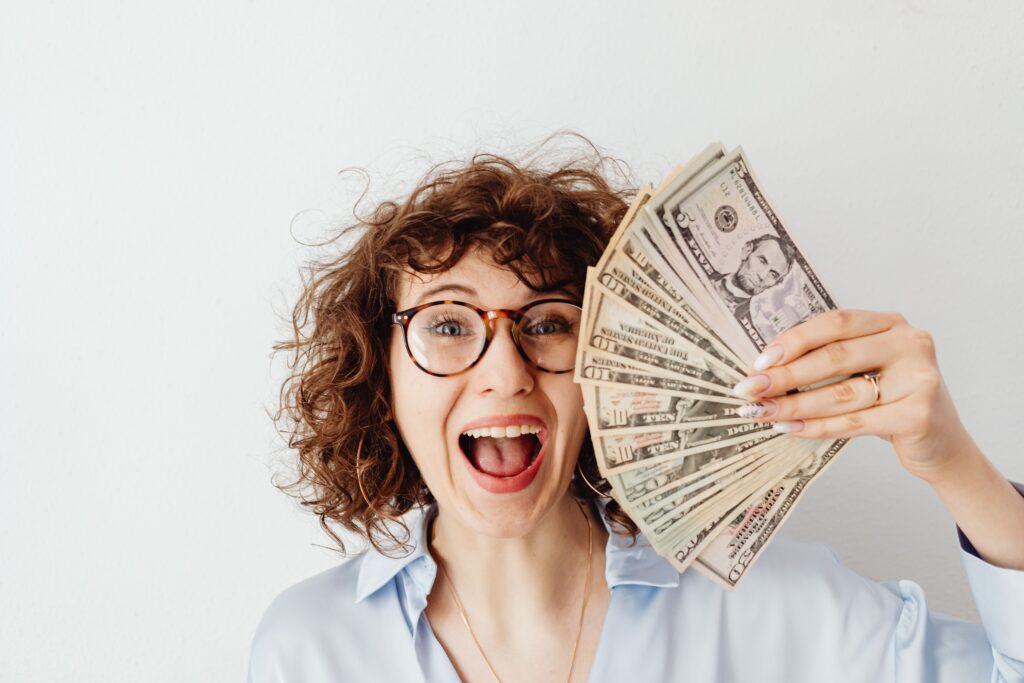 Woman holding cash representing flight delay compensation for travelers