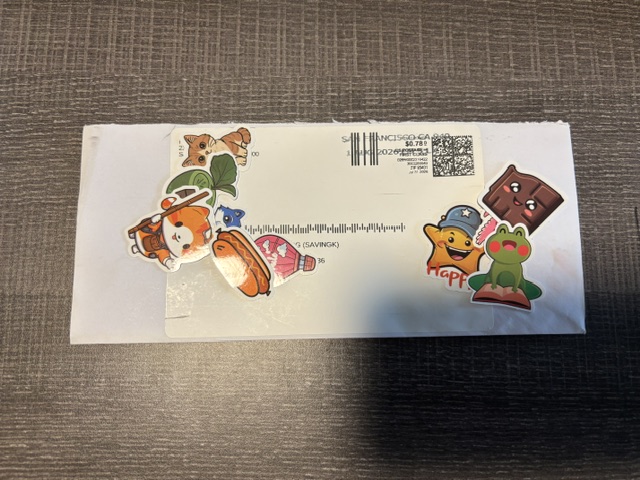 Whatnot giveaway stickers received in the mail in a stamped envelope