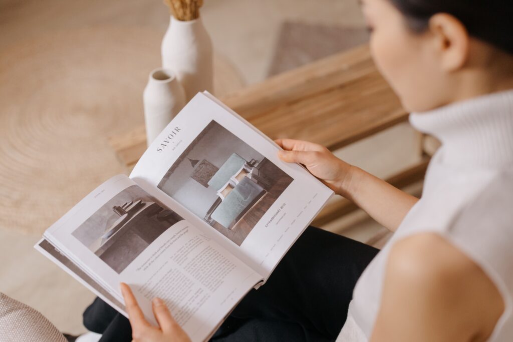 Woman browsing a home decor catalog for furniture and decorating inspiration